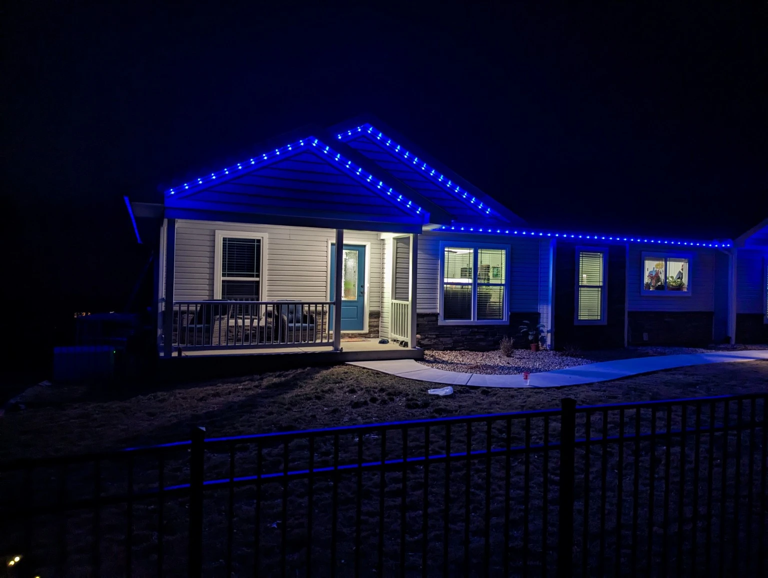 Blue lighting along the porch roofline